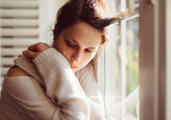 sad looking young woman, exploring the links between nutrition and mental health | Perpetual Wellbeing