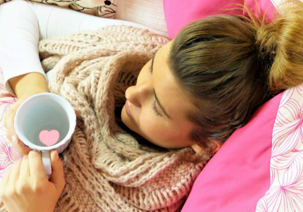 woman resting with scarf and mug | boost your immune system | Perpetual Wellbeing
