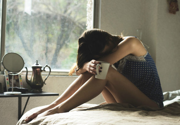 woman with head on knees | natural remedies for hormonal imbalance in females | Perpetual Wellbeing