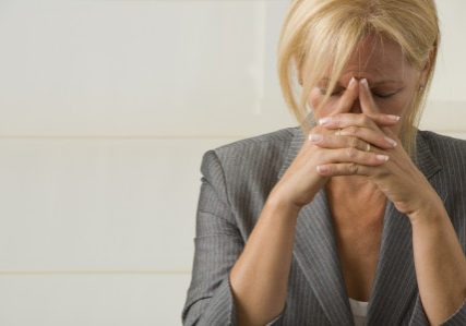 woman with eyes closed showing signs and symptoms of stress | Perpetual Wellbeing