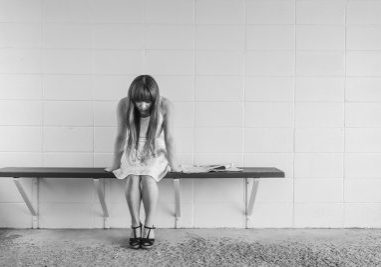 sad girl sits on bench | what causes mood disorders | Perpetual Wellbeing
